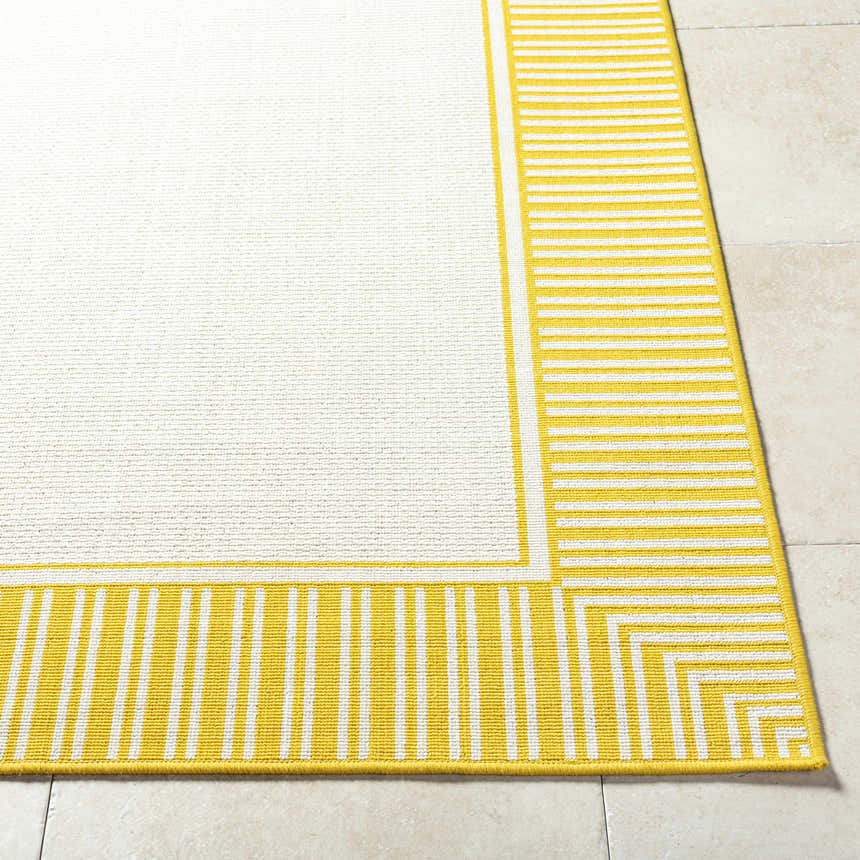 Close-up of Nadir Area Rug showing a cream center and yellow striped border. Machine woven olefin rug. Front