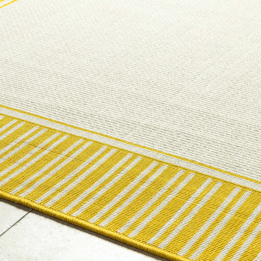 Close-up of the Nadir Area Rug; cream rug with yellow and white striped border. Texture