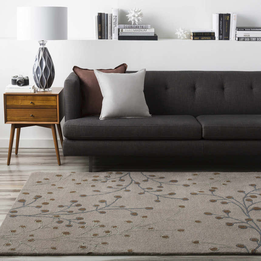 Living room scene with a Sage Brown Elsu Area Rug, gray sofa, and mid-century modern side table. Roomscene-Rectangle