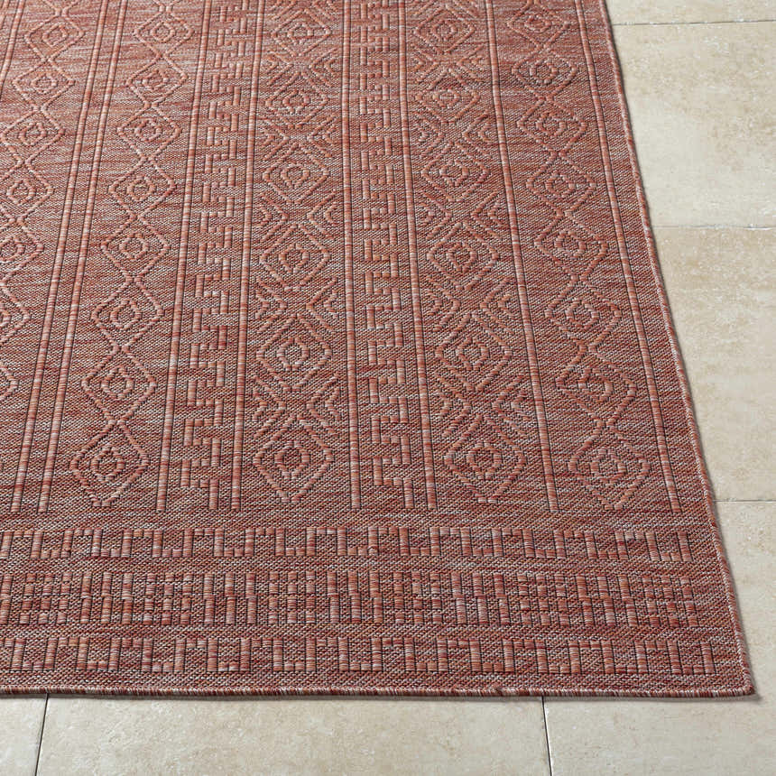 Close-up of the Nuela Burgundy Area Rug showing its diamond and geometric pattern and woven texture. Front