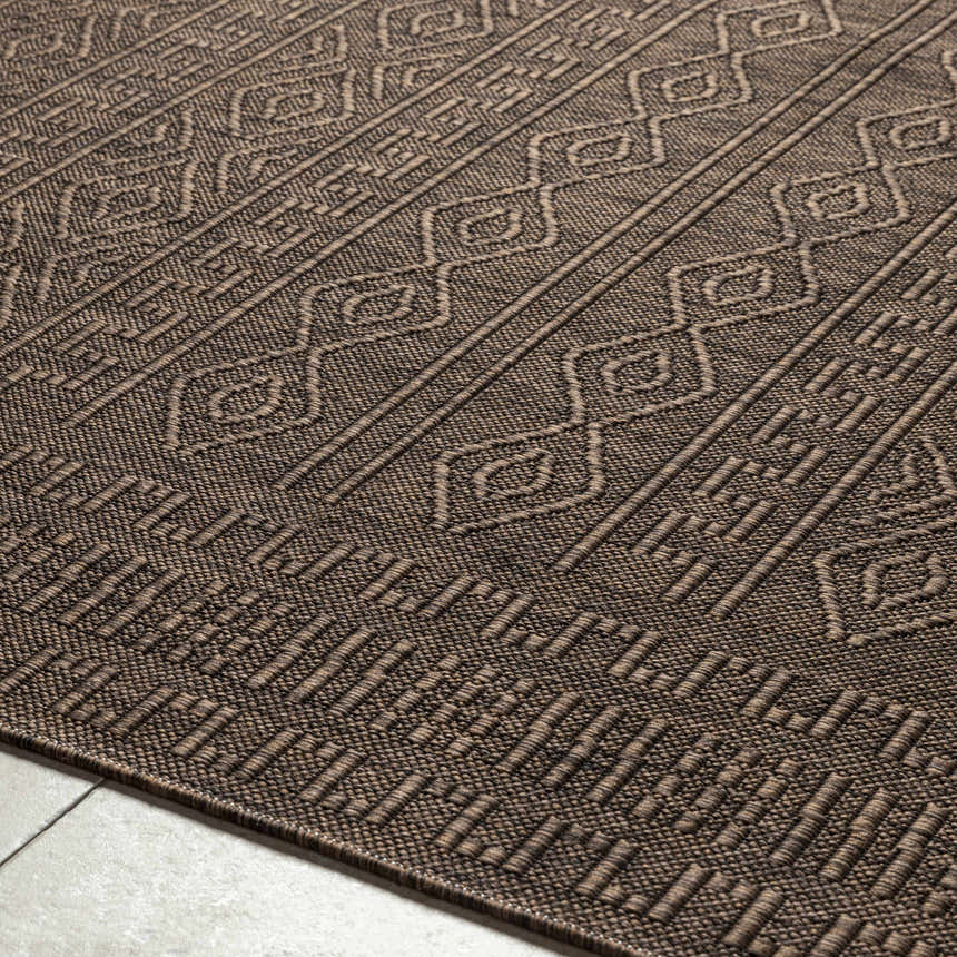 Close-up of the Nuela Dark Brown Area Rug, showing its diamond and line pattern and textured, machine-woven construction. Texture
