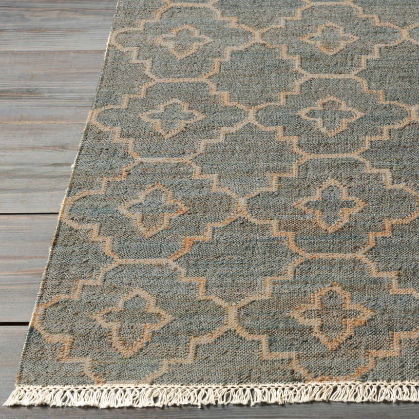 Close-up of the Niceville Handcrafted Jute Carpet in cream, gray, and tan with a geometric pattern and fringed edge. Front