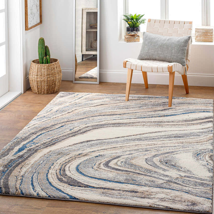 Light and airy room scene with Nillumbik Gray Marble Design Rug, woven chair, and potted plants. Roomscene-Rectangle