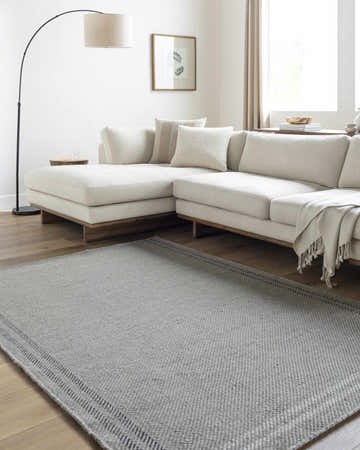 Living room with ivory sectional and gray Nimue Ivory Area Rug, a farmhouse style. Roomscene-Rectangle