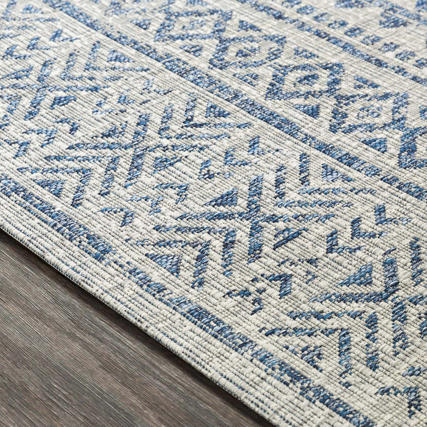 Close up of Novato All Over Pattern Performance Rug. Blue geometric design on a textured, machine woven rug. Texture