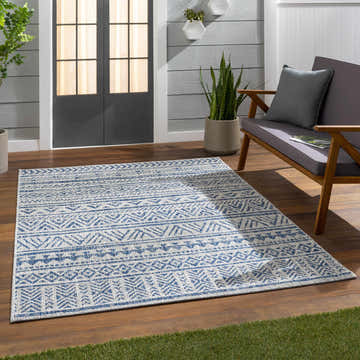Outdoor patio scene with blue Novato All Over Pattern Performance Rug, gray loveseat, wood floor, and potted plants. Roomscene-Rectangle