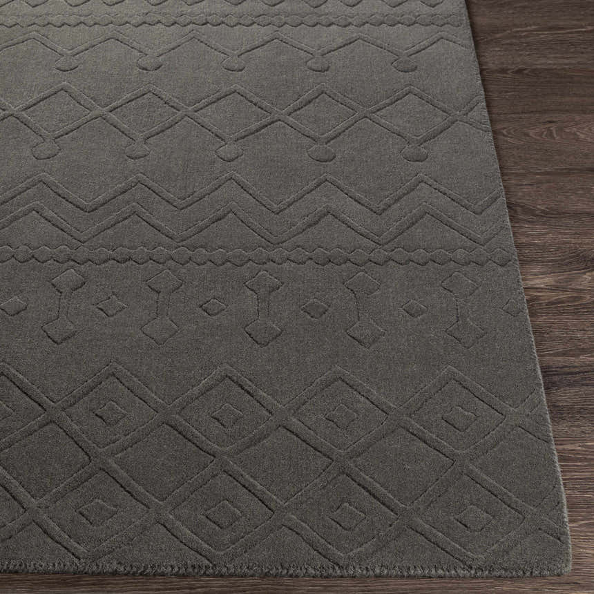 Close-up of the charcoal Newtonhill Clearance Rug. Hand-loomed wool rug with geometric farmhouse pattern. Front