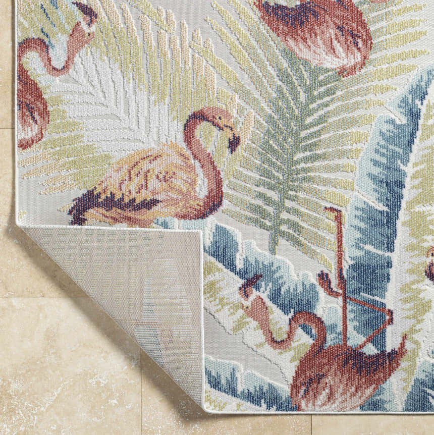 Close-up of Nayan Light Slate Area Rug with flamingo and palm leaf design in blue, cream, olive, and rust colors. Fold