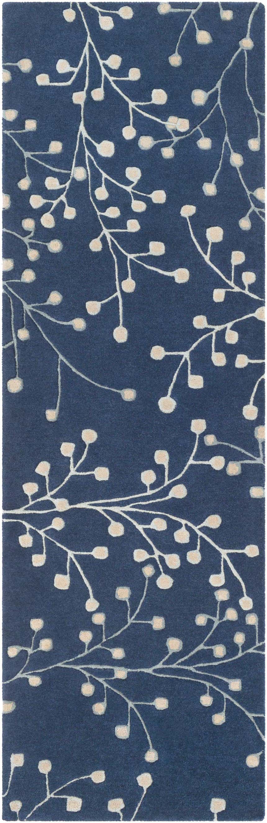 Close-up of the Blue Elsu Area Rug, featuring a floral branch pattern in tan against an ink blue background. Design-Runner-268