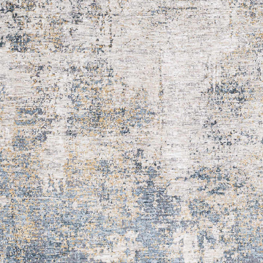 Close-up of the Odell Abstract Luxe Fringe Rug, featuring dark blue, light blue, gray, and mustard hues. Swatch
