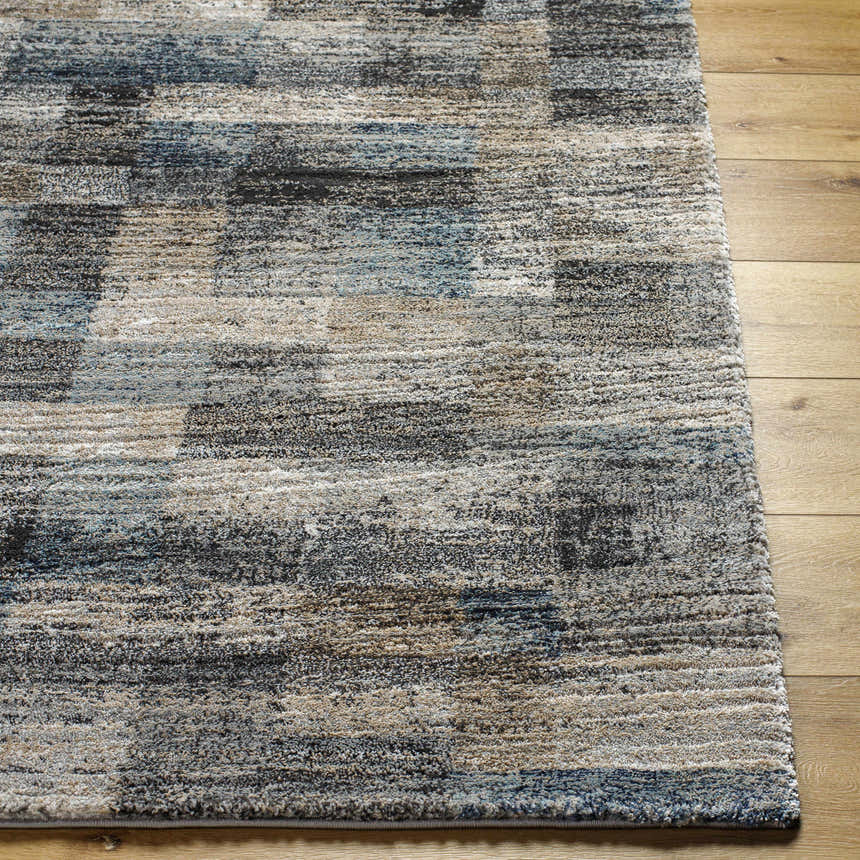 Close up of the Ohtli Mosaic Luxe Thick Area Rug, gray, smoke, and blue tones, machine woven texture. Front