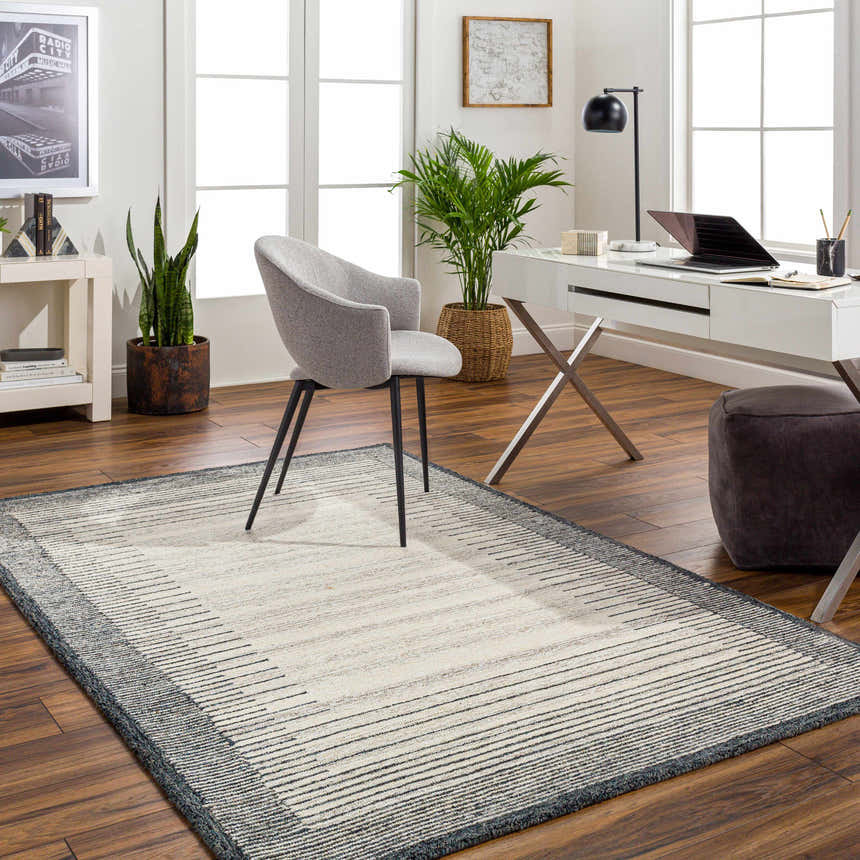 Home office with Omeo Wool Area Rug in bone and dark gray, gray chair, white desk, and wood floors. Roomscene-Rectangle