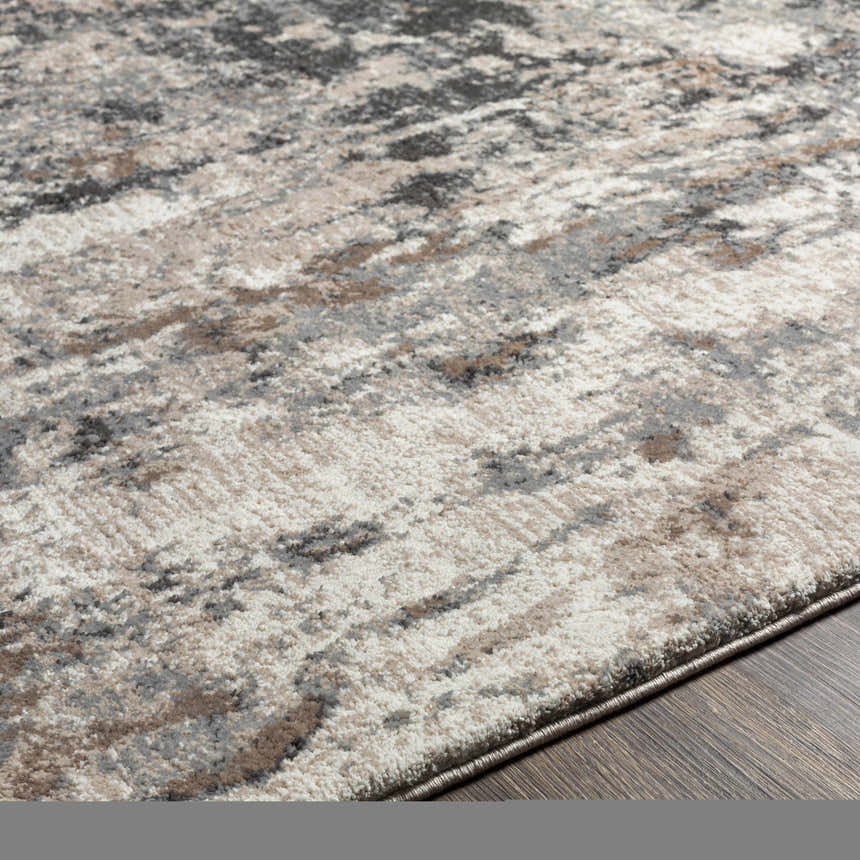 Close-up of the Opunake Luxe Thick Area Rug showing its abstract pattern in cream, gray, tan, brown, and black tones. Texture