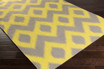 Close-up of Oradell Yellow Ikat Wool Rug showing the yellow and brown bohemian pattern and hand woven texture. Corner