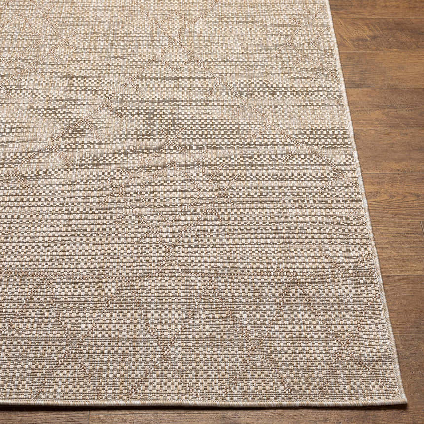 Close-up of the woven texture and pattern of the Marwood Brown Nordic Rug on a wood floor. Front