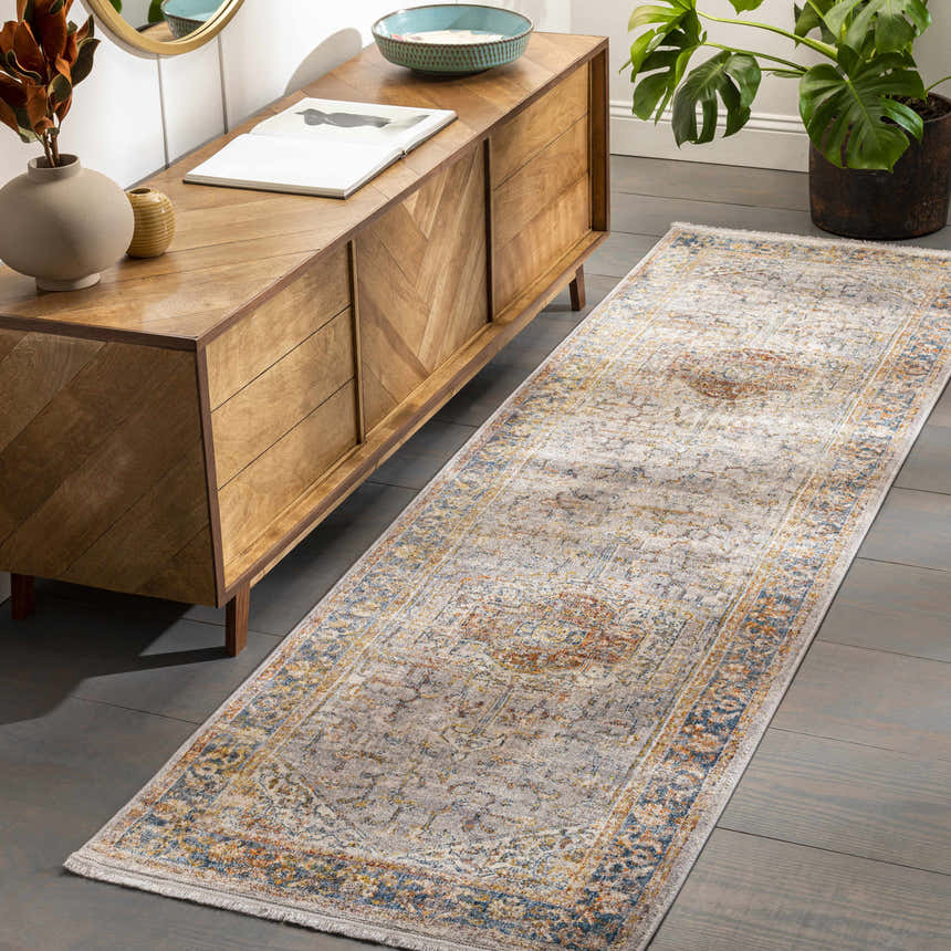 Hallway scene with Orchards Area Rug runner in brick red, burnt orange, blue, and gray. Bohemian style with wood console table and monstera plant. Roomscene-Runner