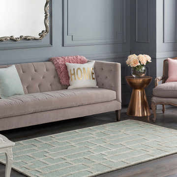 Living room scene with a beige sofa and the green Orma Area Rug. Roomscene-Rectangle