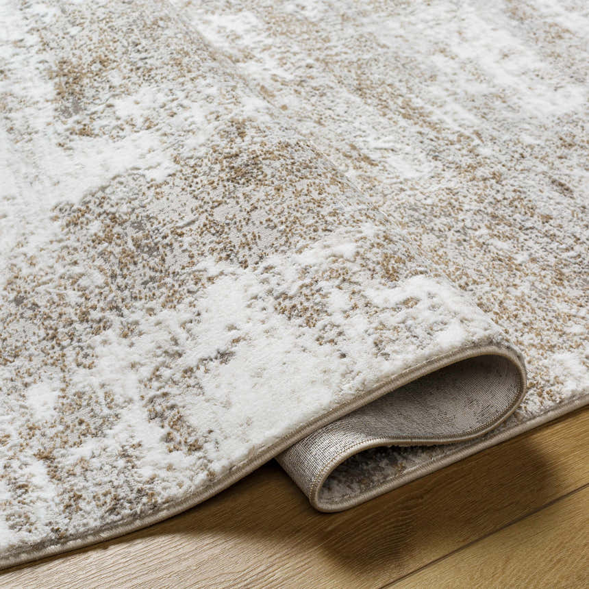 Close-up of the Oshawa Area Rug showing its driftwood, gray, and ivory abstract pattern and machine-woven texture. Fold