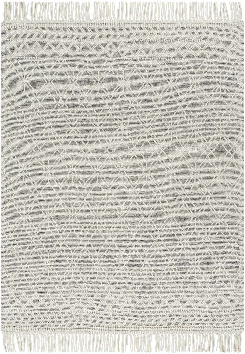 Close-up of the hand woven Ossun Wool Rug. Cream geometric pattern on black, with tassels. Farmhouse style. Design-Rectangle-7996