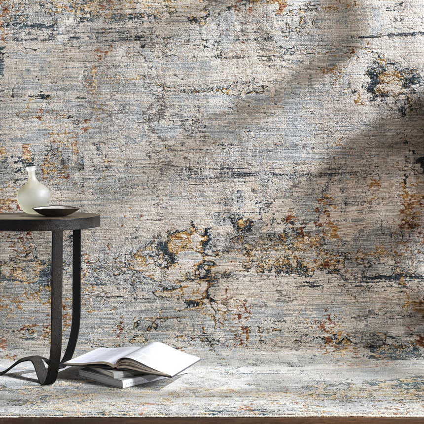 Styled Ottawa Luxe Rug in a room scene with a side table, books, vase, and neutral wall. Styleshot
