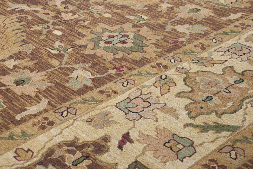 Close up of the hand knotted Palmview Area Rug, featuring beige, brown, and floral designs. Texture