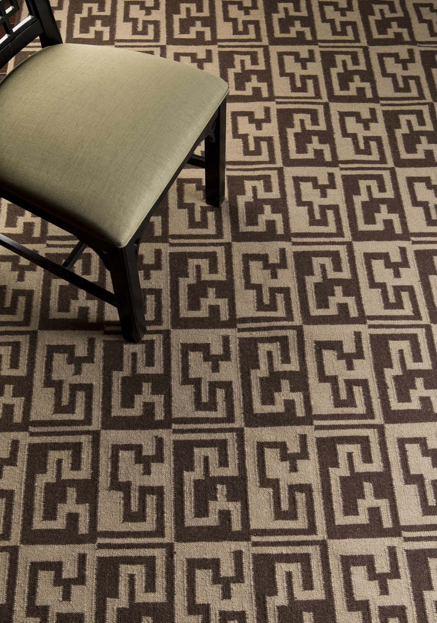 Close-up of the hand-woven Paxville Area Rug. Beige and dark red geometric pattern. Farmhouse style. Styleshot