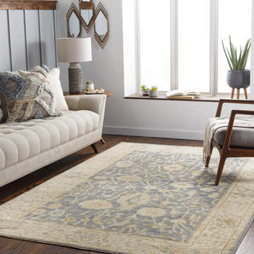 Living room scene with beige sofa and Penyffordd Area Rug in beige, charcoal, and blue oriental pattern. Roomscene-Rectangle