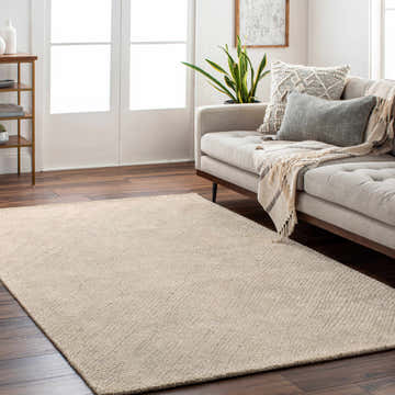 Living room scene with a tan Phalaborwa Area Rug, gray sofa, and wood floors. Roomscene-Rectangle