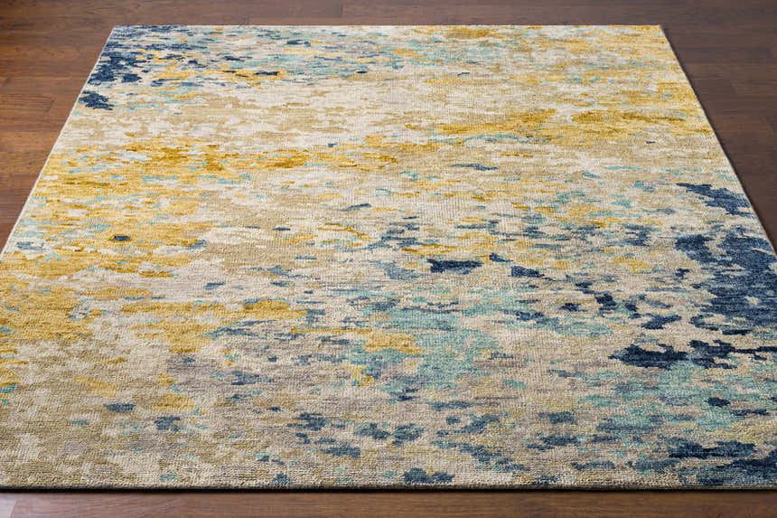 Close-up of the Pias Area Rug showing its contemporary design, beige, gray, blue, and mustard colors, and hand-knotted wool texture. Front