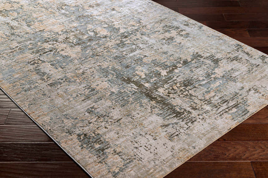 Close-up of Palanit Thick Luxe Boutique Rug with a contemporary abstract design in light beige, teal, gray, and olive tones. Corner