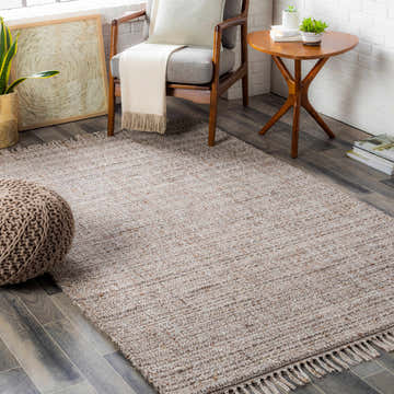 Cozy living room scene with a neutral Poolesville Area Rug, gray chair, and wooden accents. Contemporary style. Roomscene-Rectangle