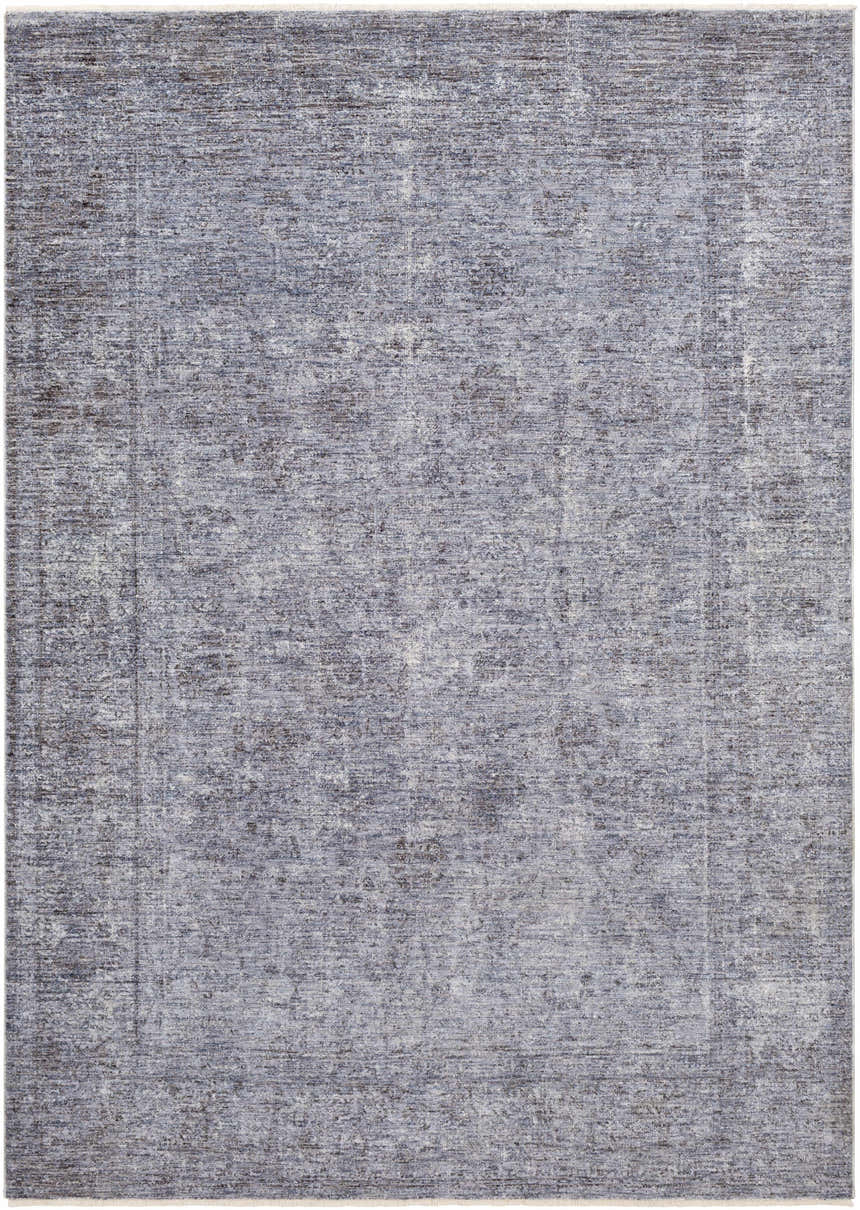 Close-up of the Plympton Carved Statement Rug, showing a textured pattern in shades of blue, gray, and ivory. Design-Rectangle
