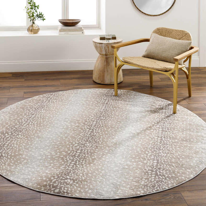 Living room scene with round Pointblank Tan Leopard Print Rug, gold chair, and wood accents. Roomscene-Round
