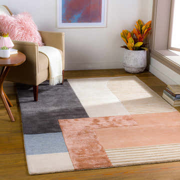 Living room scene with the Pofadder Viscose&Wool Patchwork Rug. Geometric design in blue, red, charcoal, and beige tones. Roomscene-Rectangle