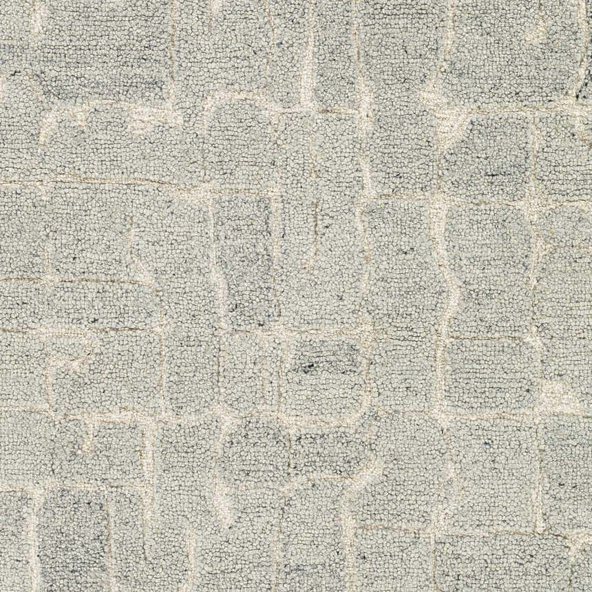 Close-up of the hand-tufted Posof Area Rug. Light beige wool rug with a contemporary light gray, medium gray, and peach block pattern. Swatch