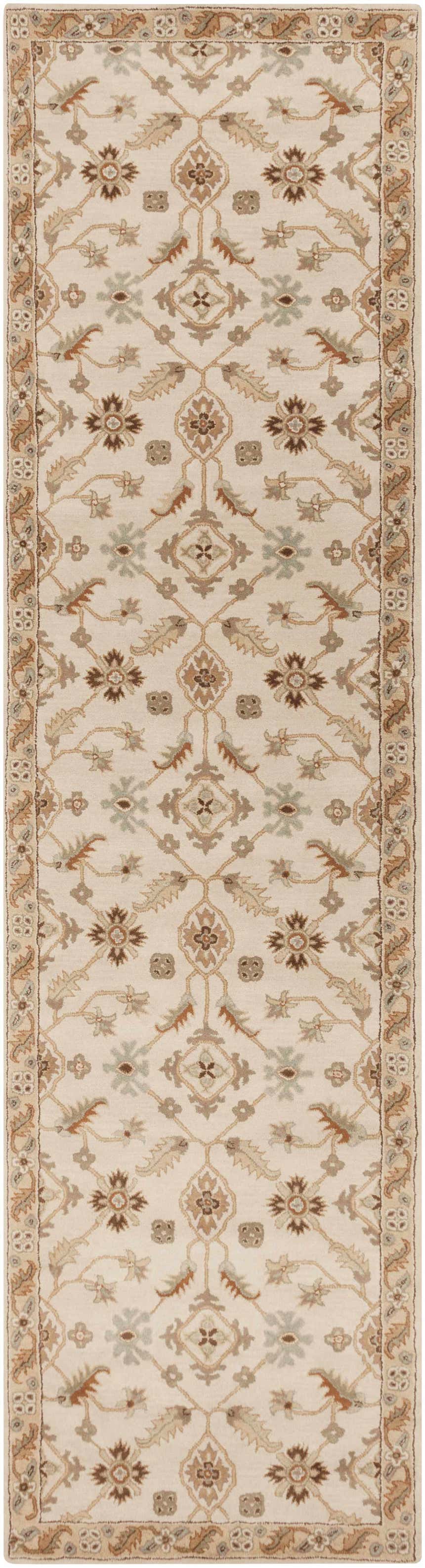 Close-up of the Postelle Wool Rug. Features a traditional floral pattern in brown, tan, and sage on an ivory background. Design-Runner