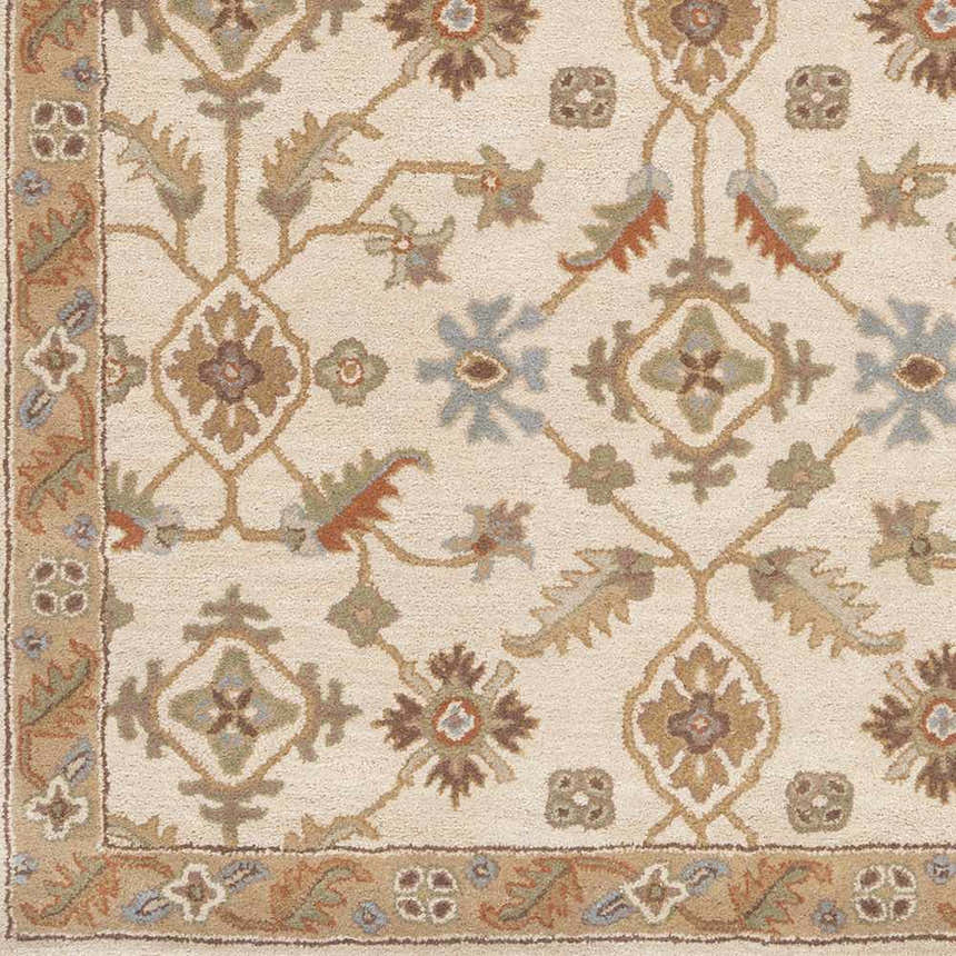 Close-up of the Postelle Wool Rug, featuring a traditional floral pattern in brown, sage, and tan on a cream background. Swatch