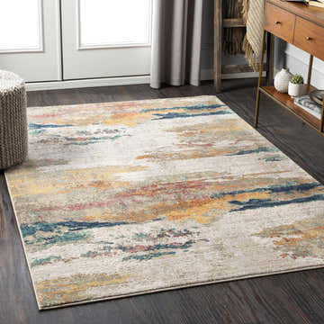 Living room scene with a Pearces Area Rug in cream, gray, mustard, and peach tones on dark wood floors. Modern console table. Roomscene-Rectangle