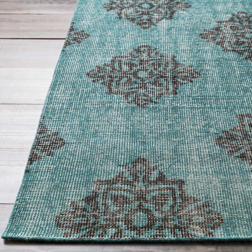 Close-up of the hand-knotted Presidio Area Carpet. Emerald rug with a black, diamond-shaped medallion pattern. 100% wool. Front