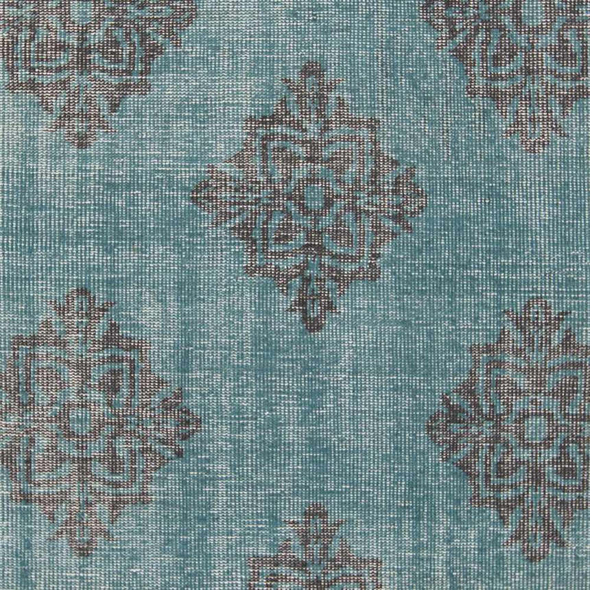 Close-up of Presidio Area Carpet. Emerald wool rug with a traditional black diamond medallion pattern. Hand-knotted texture. Swatch