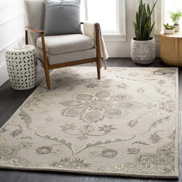 Living room scene with a beige armchair on a Peterstown Beige Wool Rug with a floral pattern. Roomscene-Rectangle