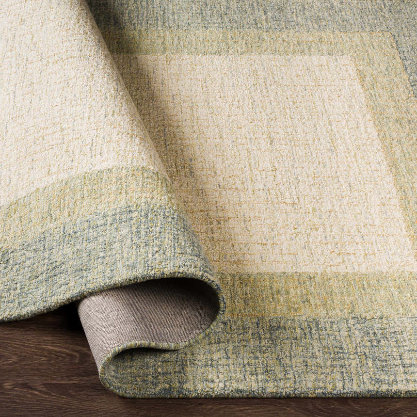 Close-up of the hand-tufted Pualas Area Rug. Cream, sage, and beige stripes create a contemporary, textured design. 100% Wool. Fold