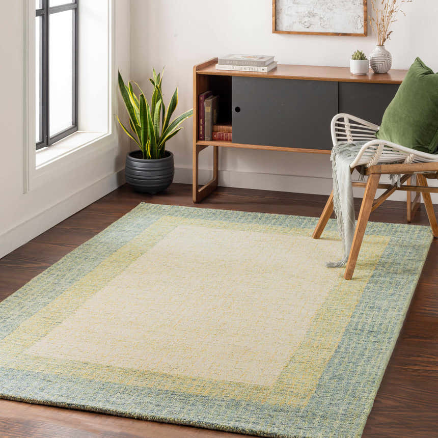 Living room scene with a Pualas Area Rug in cream, sage, beige, and olive colors. Modern decor with wood accents. Roomscene-Rectangle