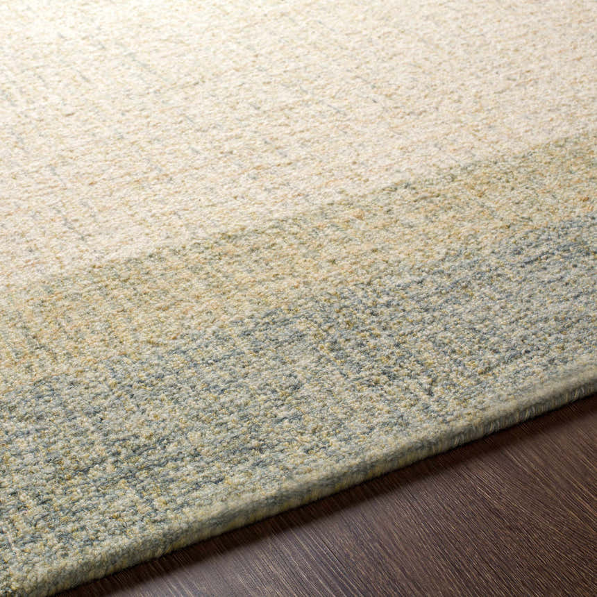 Close up of the hand tufted Pualas Area Rug. Cream, sage, and beige wool stripes add texture and color. Texture