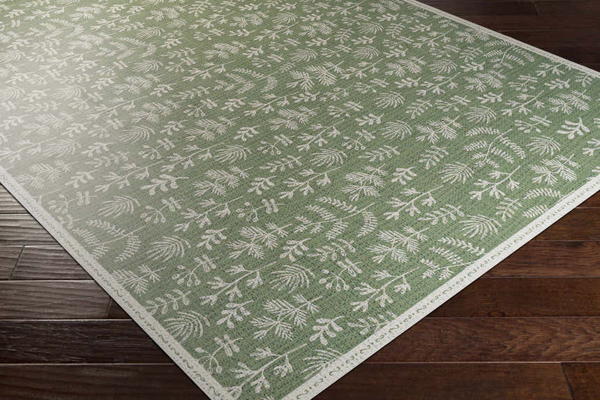 Close-up of the Pulteney Area Rug, a cream and olive vinyl rug with a contemporary botanical pattern. Corner