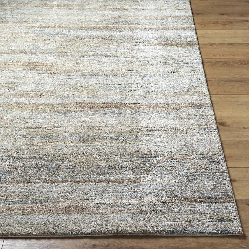 Close-up of the Agueda Thick Luxe Rug. Beige, tan, light gray, and olive hues with a soft, textured design. Front