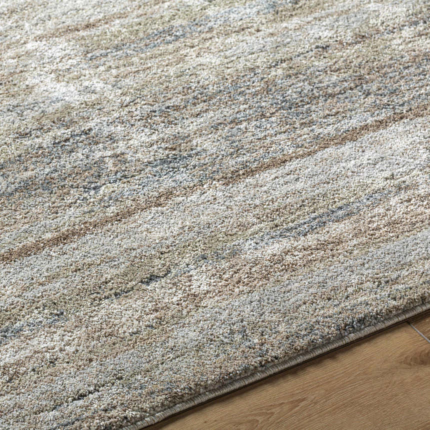 Close up of the Agueda Thick Luxe Rug showing beige, light gray, olive, tan, and teal colors with a textured, contemporary design. Texture