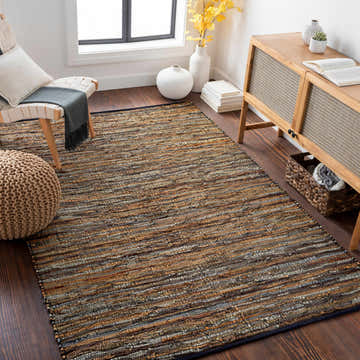 Living room scene with a hand woven leather rag rug in brown, gray, and tan tones. Modern wood furniture and decor. Roomscene-Rectangle