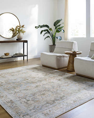 Living room scene with beige Waqar Area Rug, white chairs, wood floors, and console table. Roomscene-Rectangle