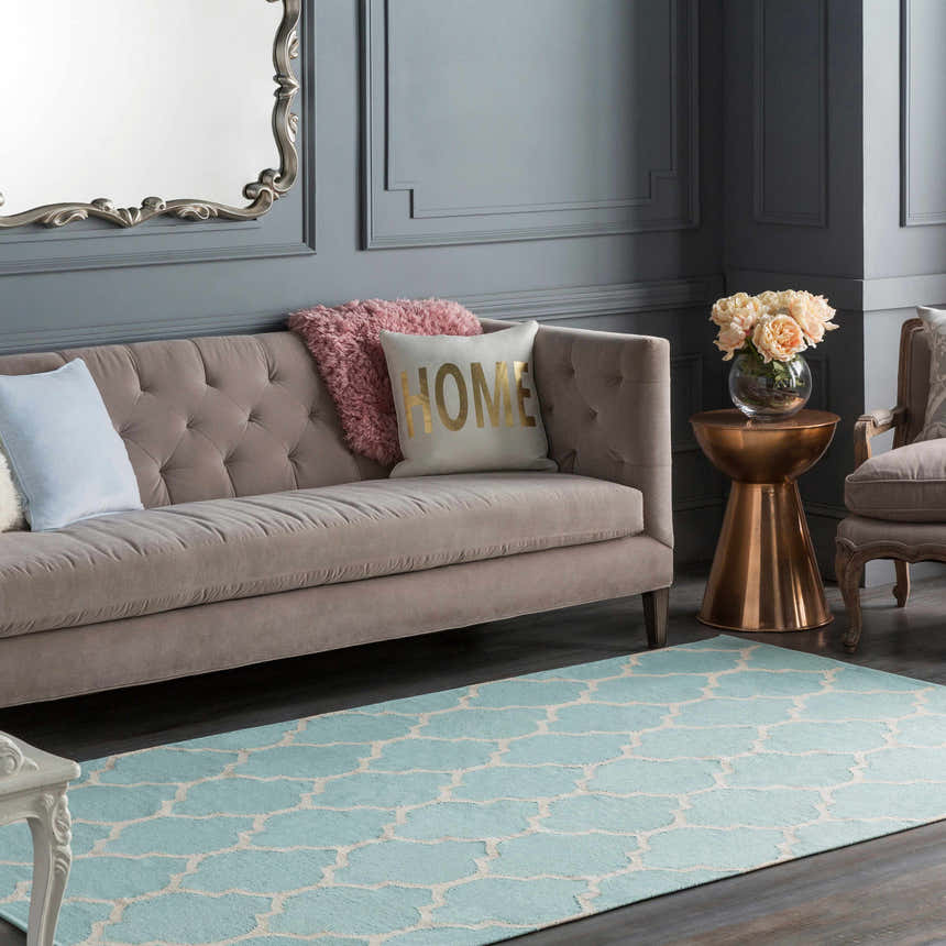 Living room scene with a Ragan Ice Blue Trellis Cotton Rug, taupe sofa, copper accent table, and gray walls. Roomscene-Rectangle